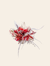 The Aries Flower Ring by CAMELLIA is a vibrant, abstract bouquet with red and white feathers, textured red foliage, and silver accents on a light background. This customizable handcrafted piece fits any space, adding unique elegance like a delicate flower ring.